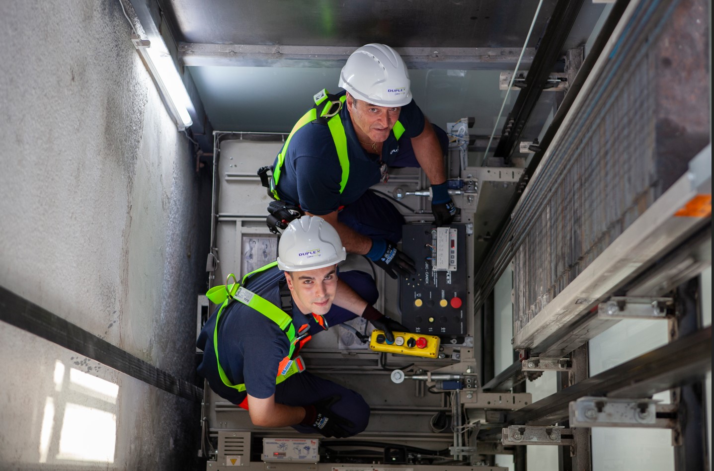 Dos técnicos de DUPLEX comprueban el funcionamiento seguro de un ascensor